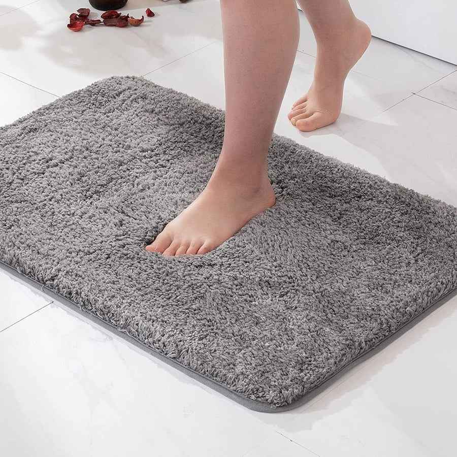 Soft blue bath mat on a bathroom floor