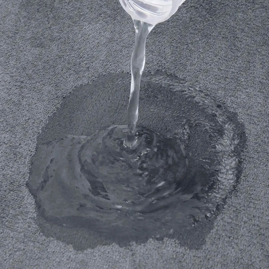 Gray bath mat shown on a tiled floor