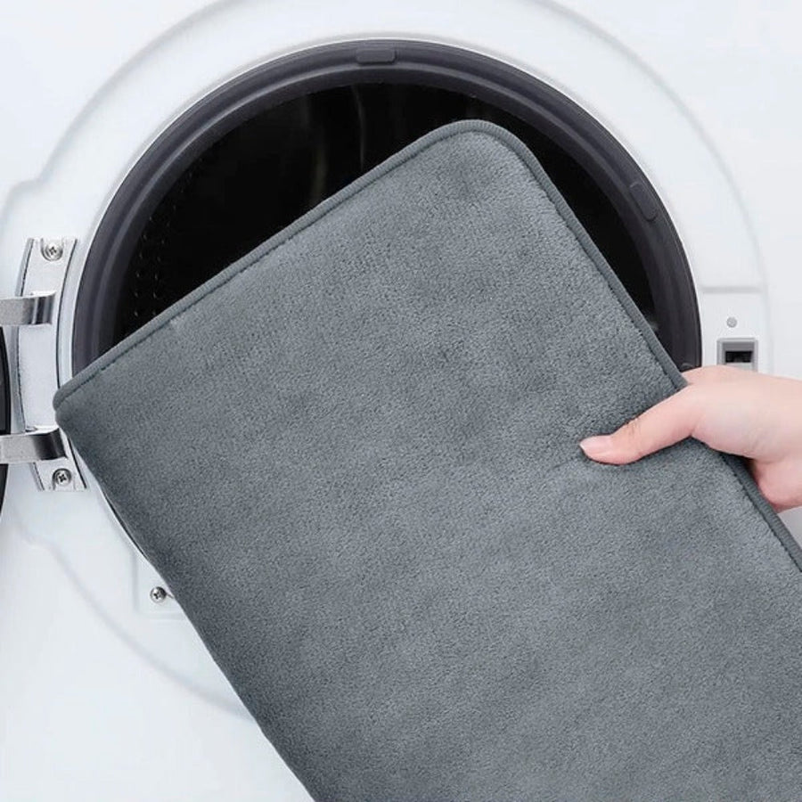 Bath mat placed beside a bathtub