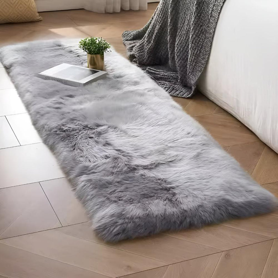 Folded sofa cover displayed in gray fabric