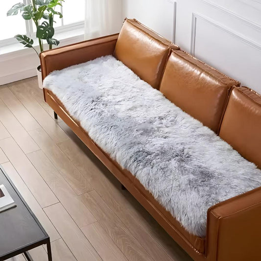 Protective sofa cover draped over a couch