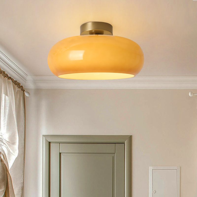 Round ceiling light fixture in a modern bedroom