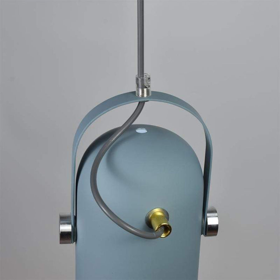 Multiple pendant lamps grouped together over a counter