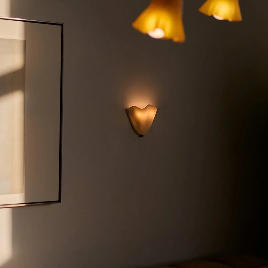 Wall lamp viewed from below showing the shell shape