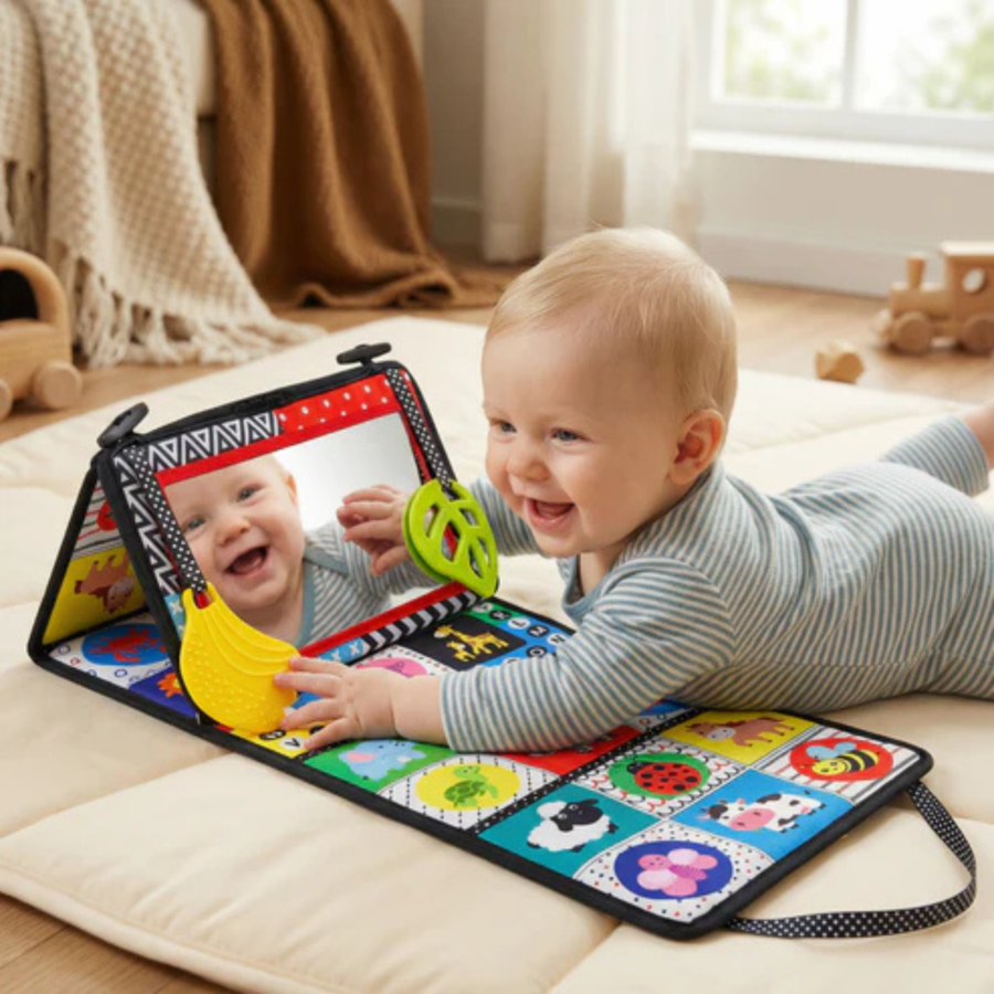 Close-up of a colorful mirror book page with a baby reaching for it.
