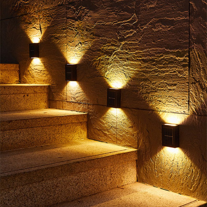 Black solar LED wall light mounted outdoors