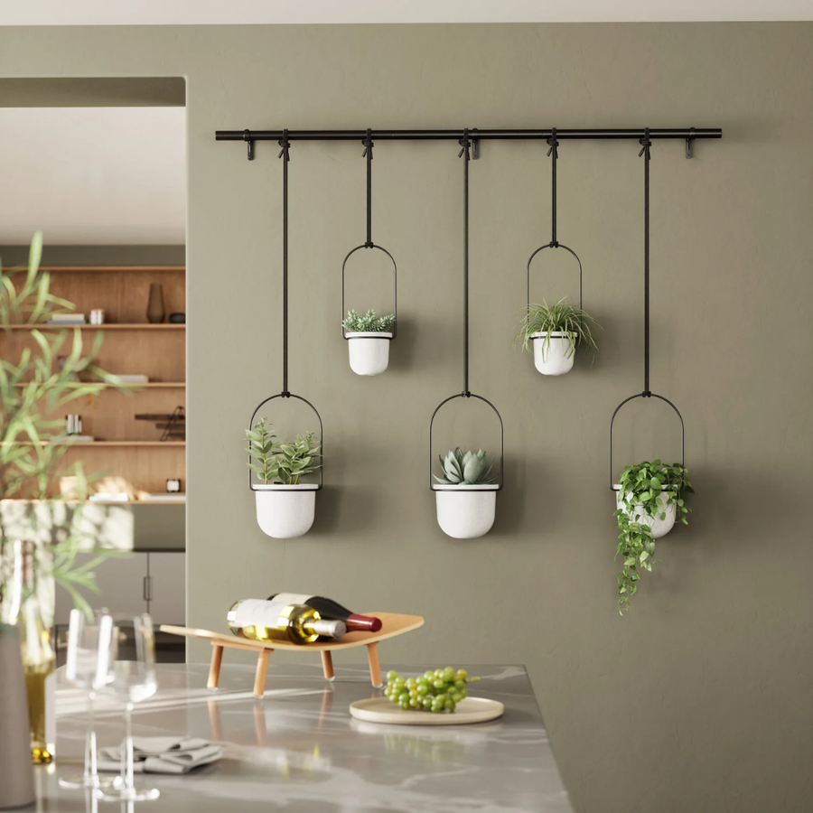 Close-up of a sleek hanging planter holder in a modern room