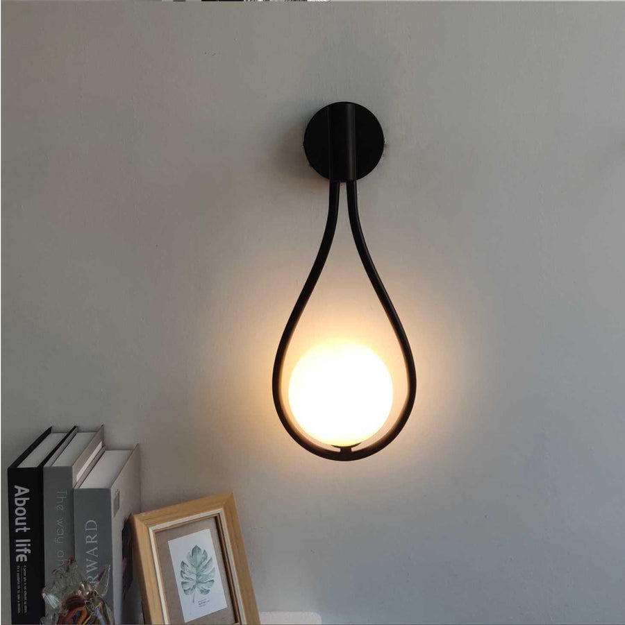 Mid-century LED wall sconce mounted on a light wall.