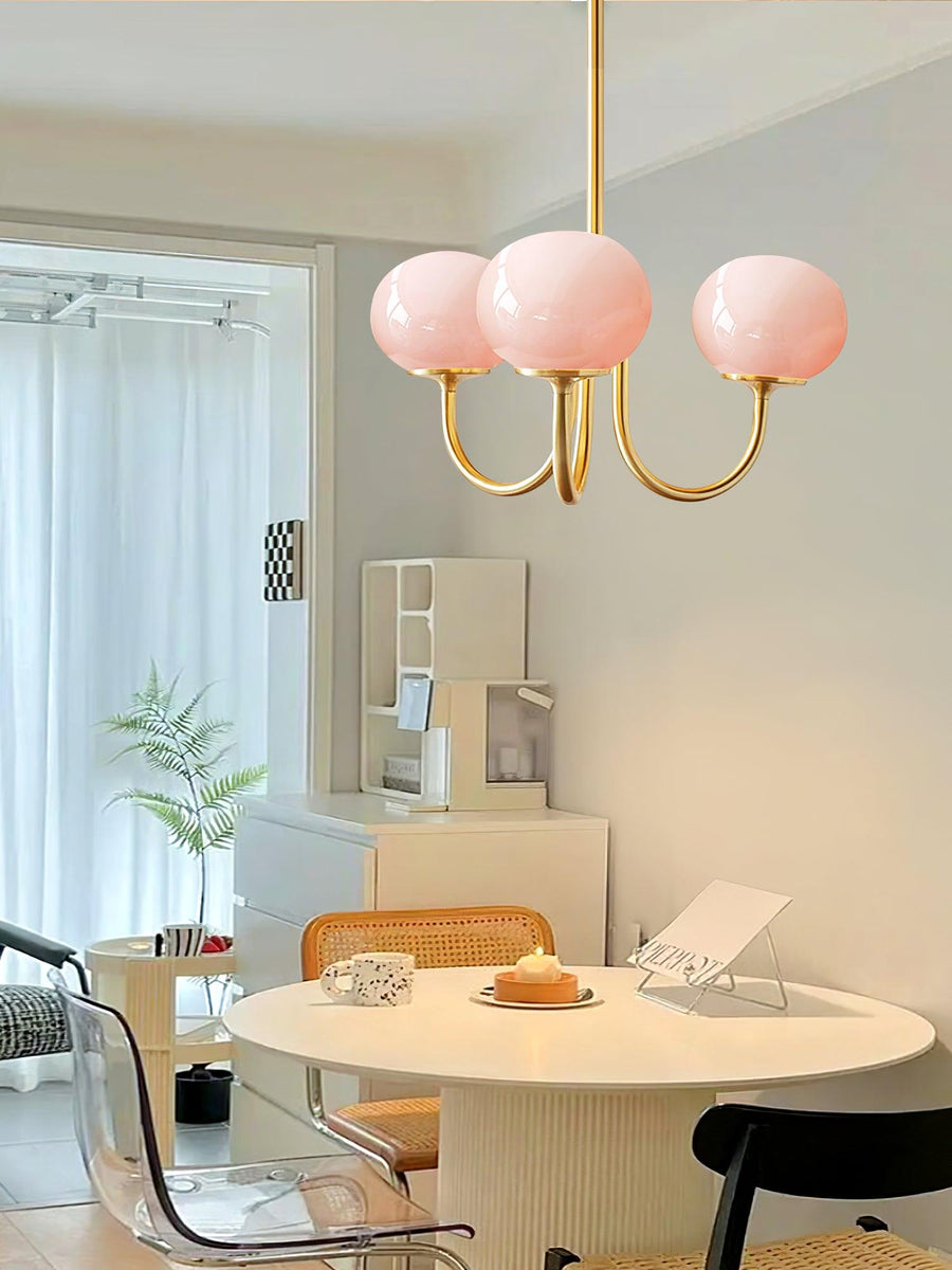 Side view of copper chandelier with cream shades
