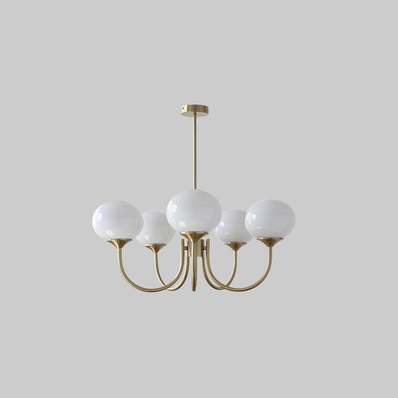 Chandelier lit against a light wall backdrop