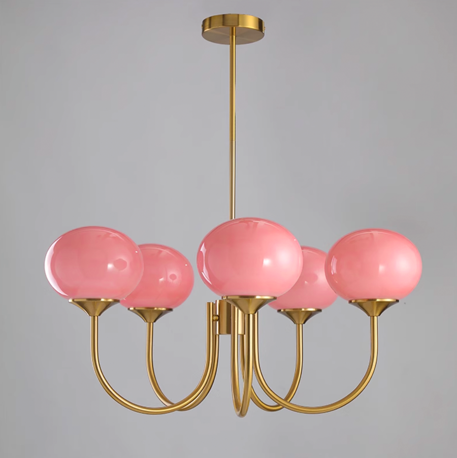 Chandelier lit warmly above a lounge area