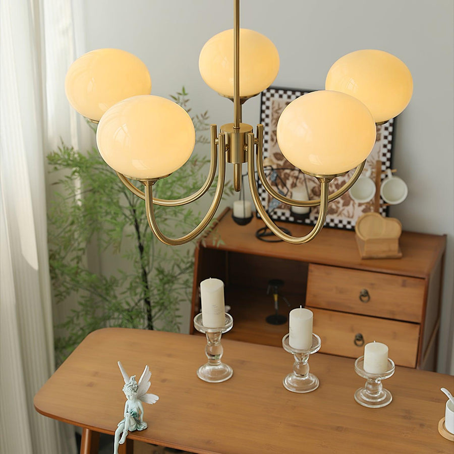 Chandelier hanging over a bedside table