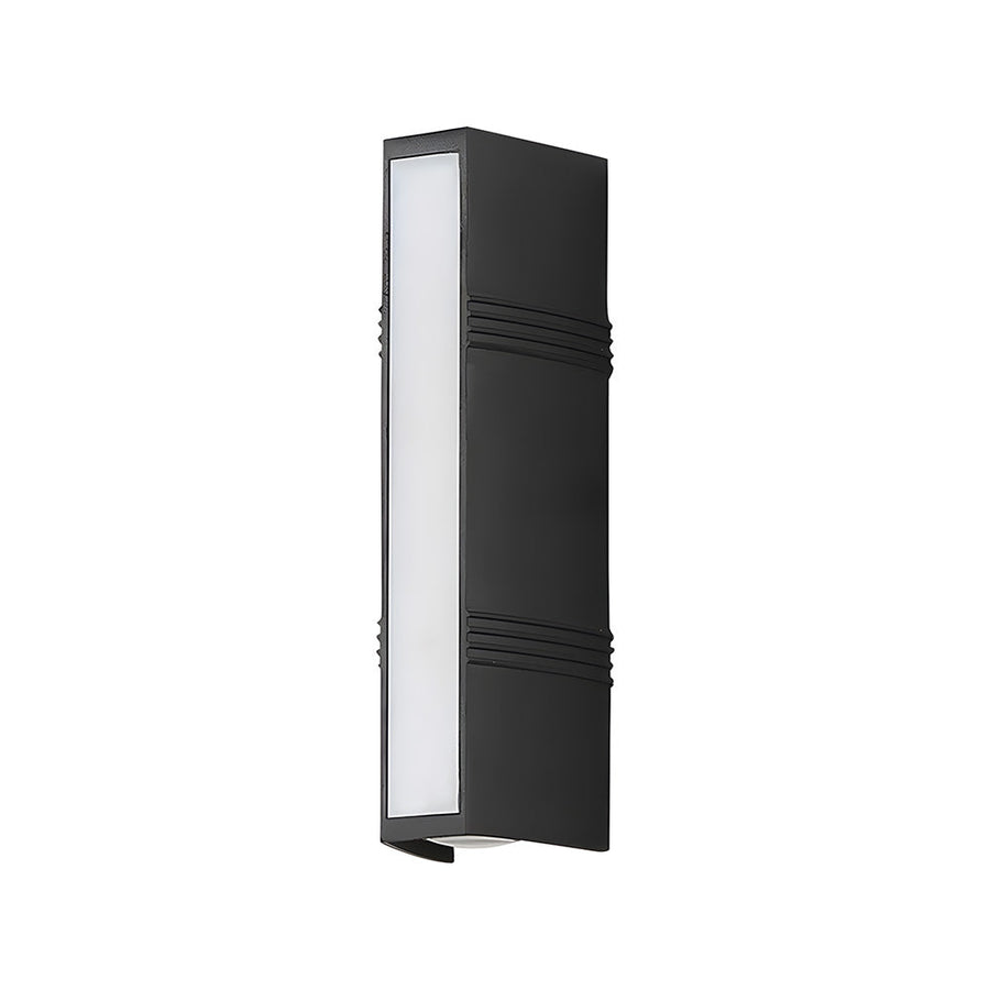 Outdoor wall light glowing softly in the evening