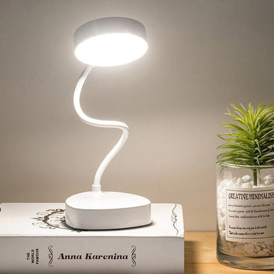 Portable touch-control desk lamp with a flexible neck on a table