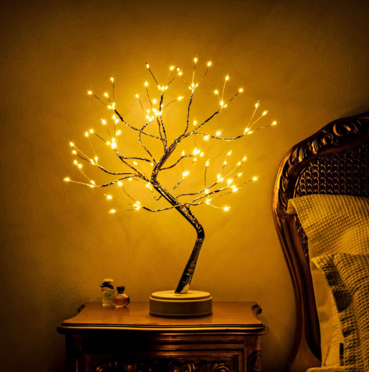 Modern LED tree-shaped table lamp on a wooden surface