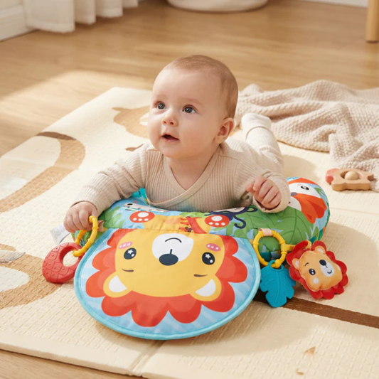 Baby lying face down on a soft tummy time training pillow