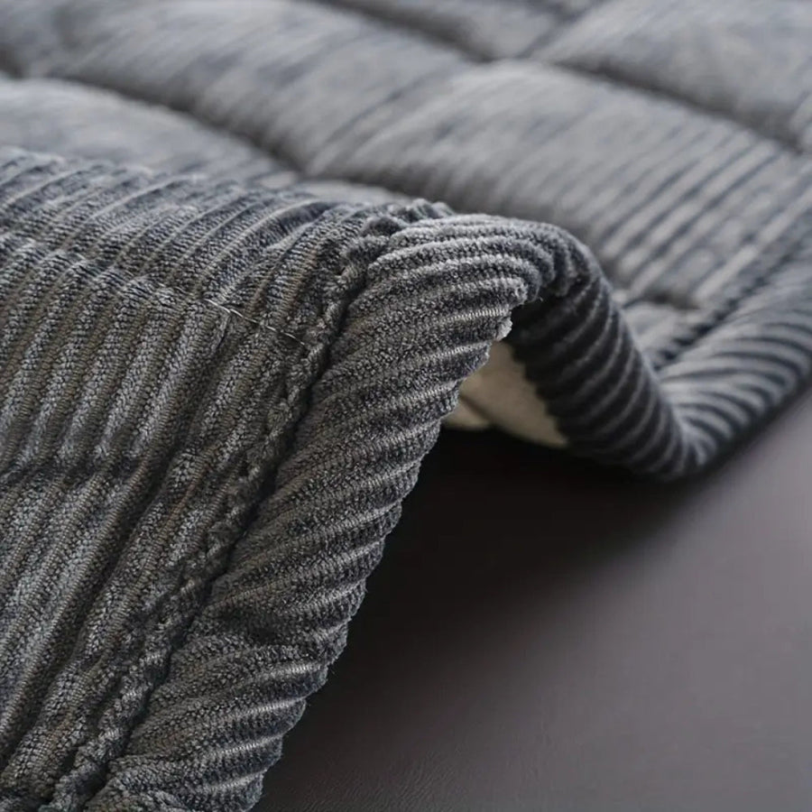 Sofa cover in a neutral color on a couch