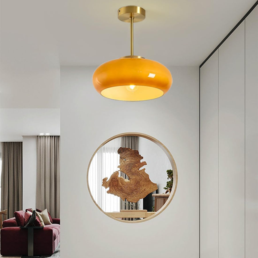 Pendant version of the round ceiling light hanging in a living room