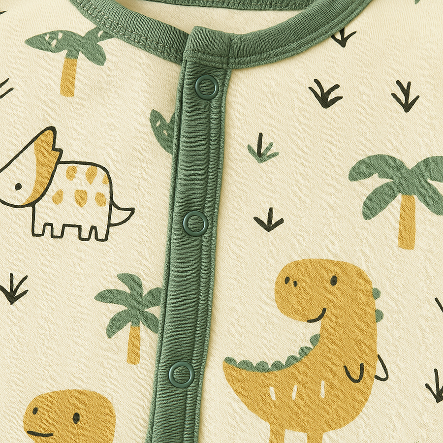 Baby romper with dinosaur print and contrast trim against a soft background