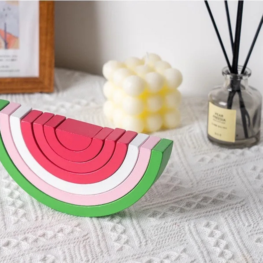 Rainbow stacking toy displayed with soft, rounded wooden pieces.