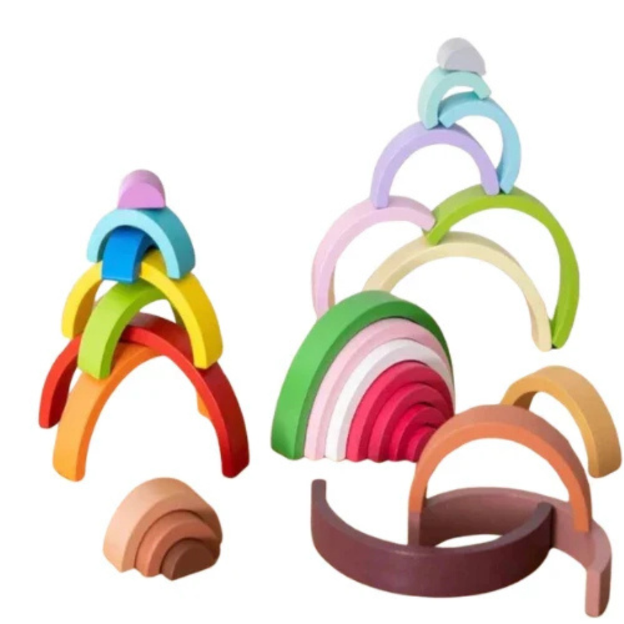 Wooden rainbow stacking toy in pastel colors on a white background.