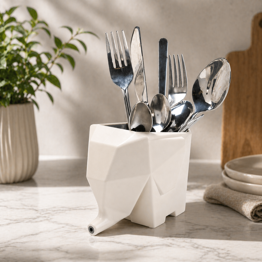 Yellow elephant-shaped organizer draining water from utensils.