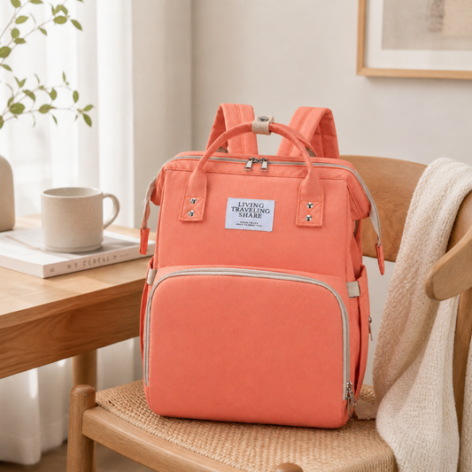 Diaper bag backpack shown from the front with multiple pockets.