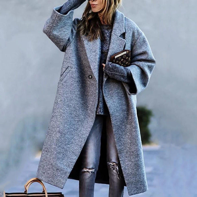 Woman in a long trench coat walking outside
