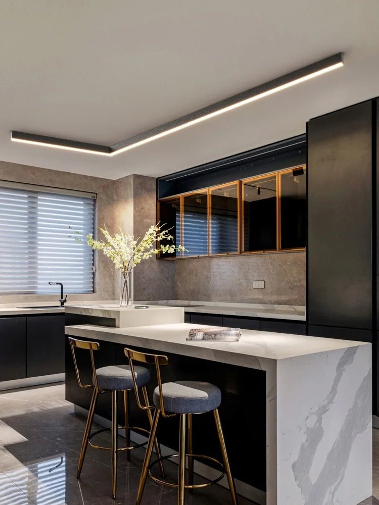 Linear LED ceiling light in black finish over a kitchen island
