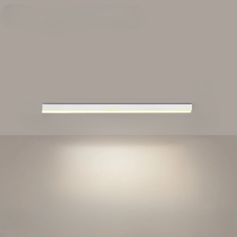 Linear LED ceiling light glowing with warm white light