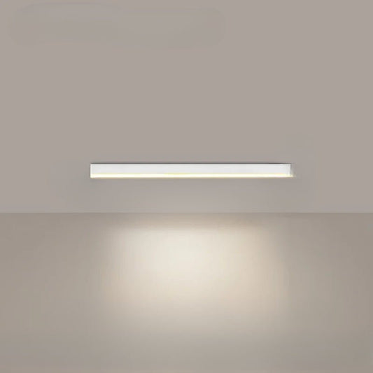 Minimalist linear LED ceiling light mounted above a dining table