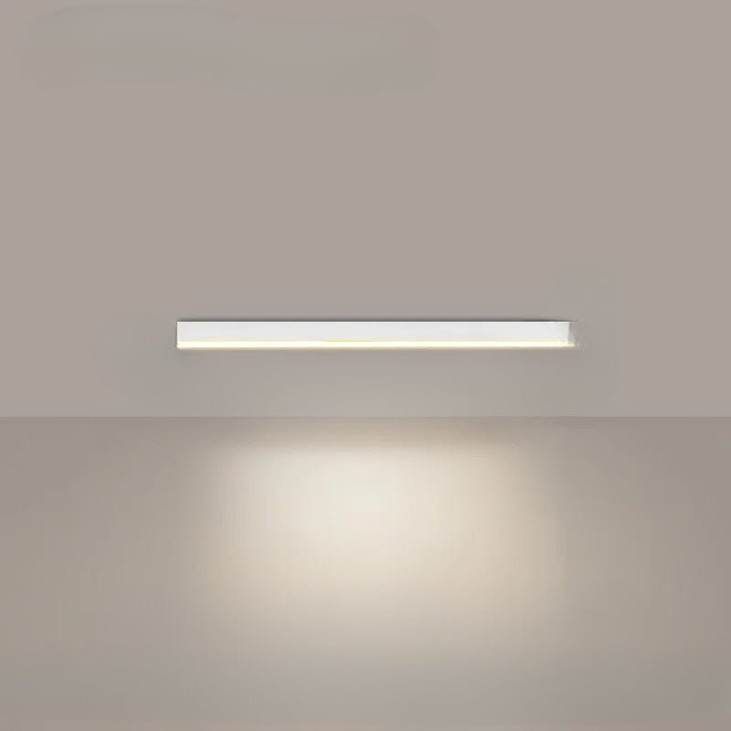 Minimalist linear LED ceiling light mounted above a dining table