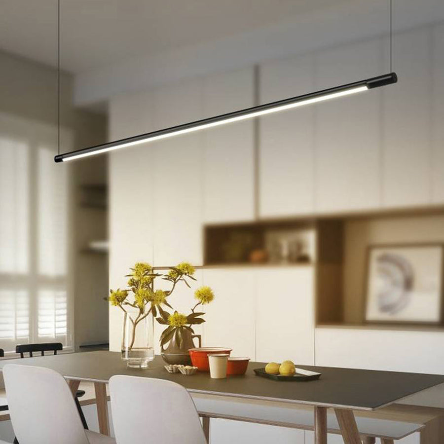 Minimalist modern LED pendant light mounted above a dining table