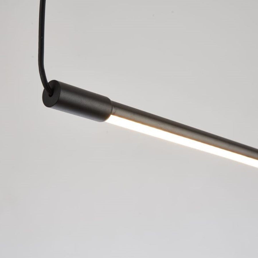 Minimalist modern LED pendant light shown in a bedroom setting