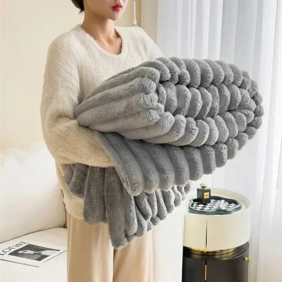 Fluffy blanket in ocean blue folded on a chair