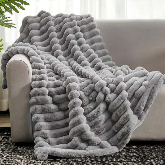 Fluffy warm striped blanket draped over a couch