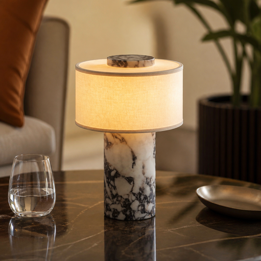 Marble and linen table lamp on a table.