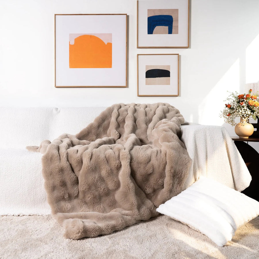 Throw blanket draped over the foot of a bed