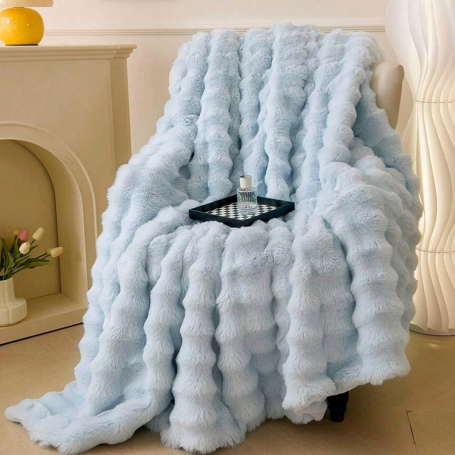 Throw blanket folded neatly on a bed