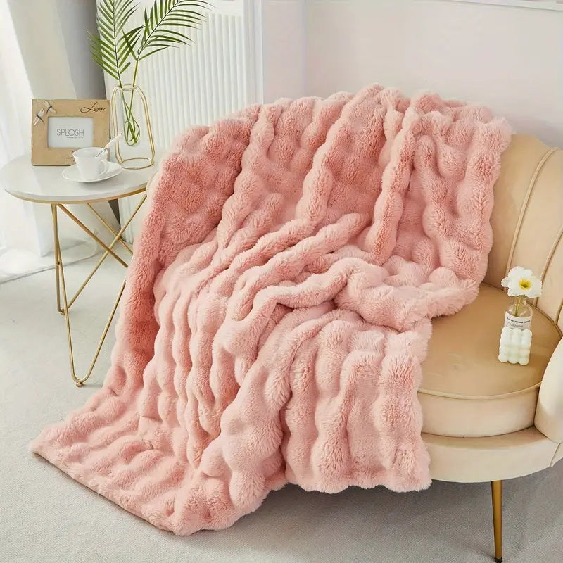 Powder Pink throw blanket draped over an armchair