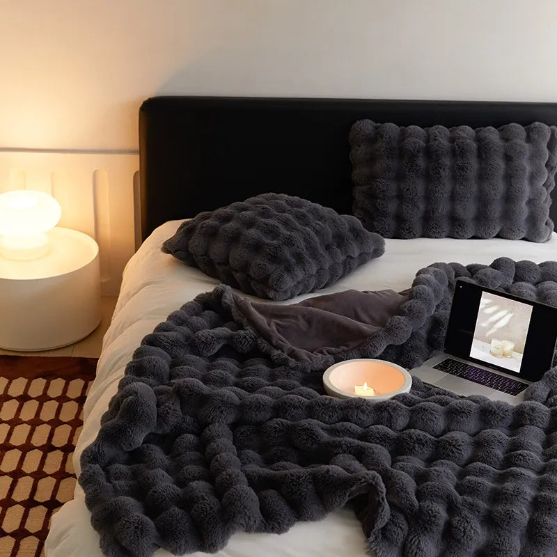 Cozy Blue throw blanket folded on a shelf