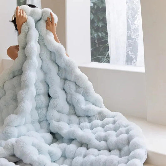 Faux fur throw blanket draped over a sofa