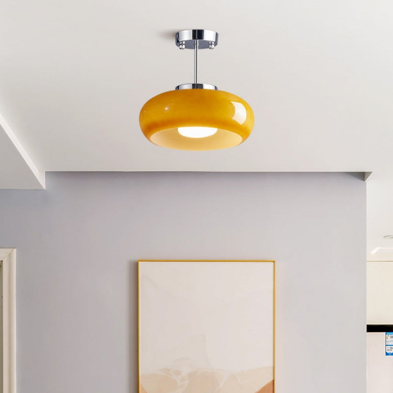 Round ceiling light fixture installed in a hallway