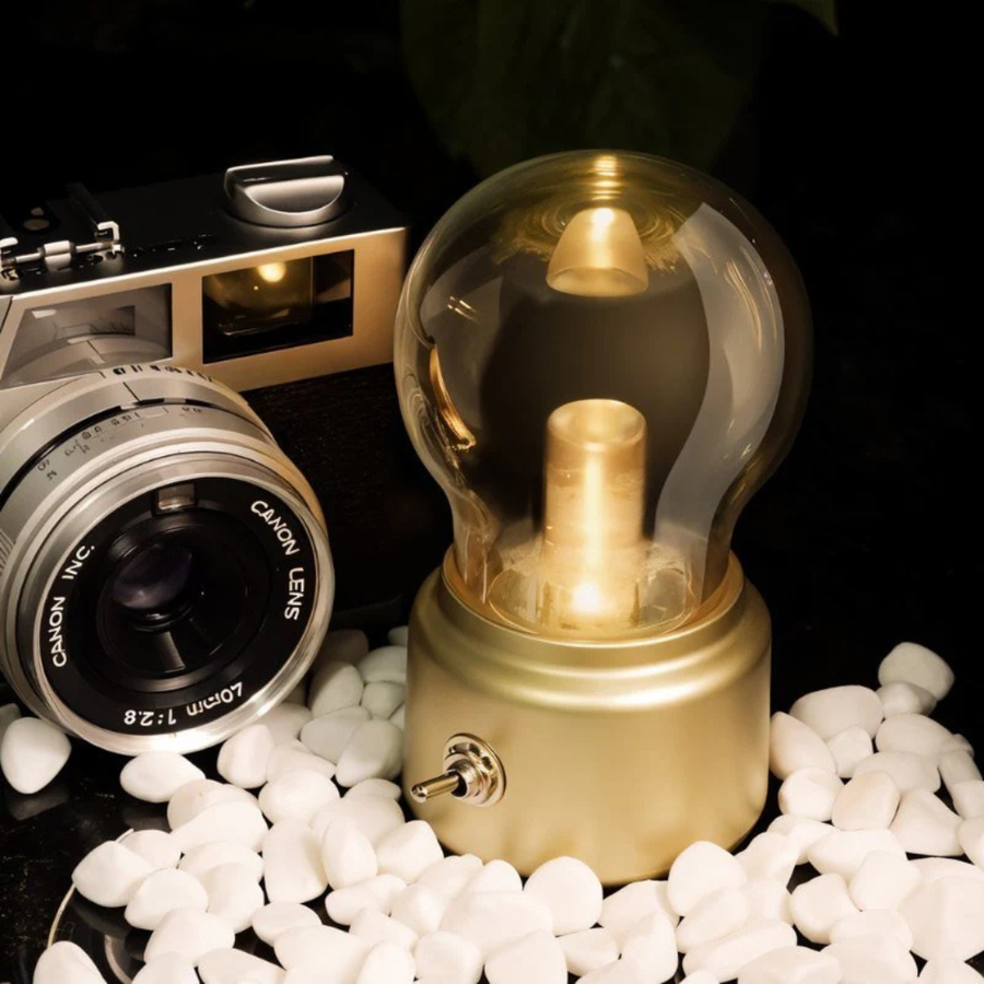 Retro rechargeable bulb lamp on a wooden desk