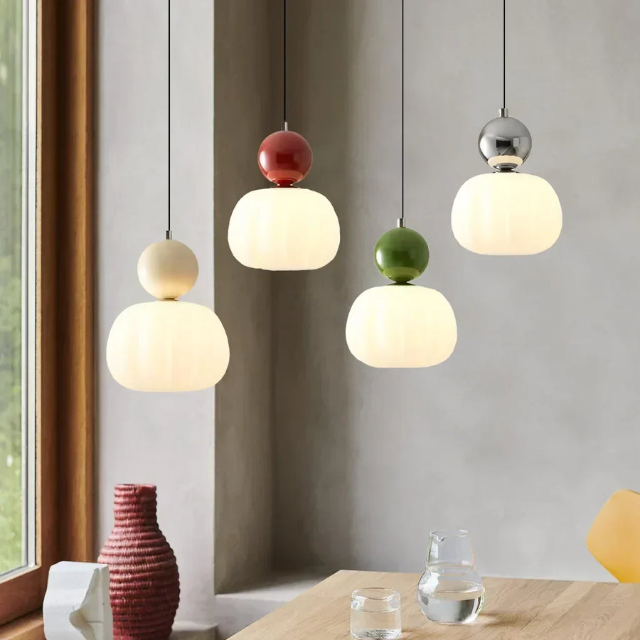 Art Deco style LED pendant light in beige finish hanging from ceiling