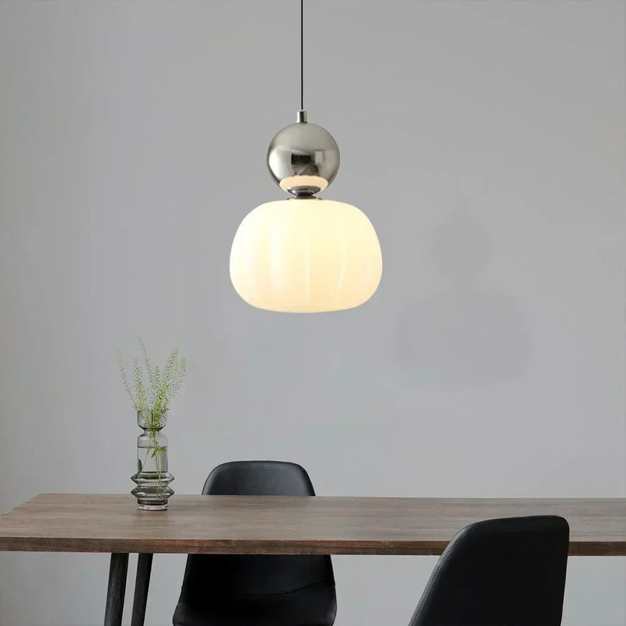 Green pendant light illuminated in a dark room