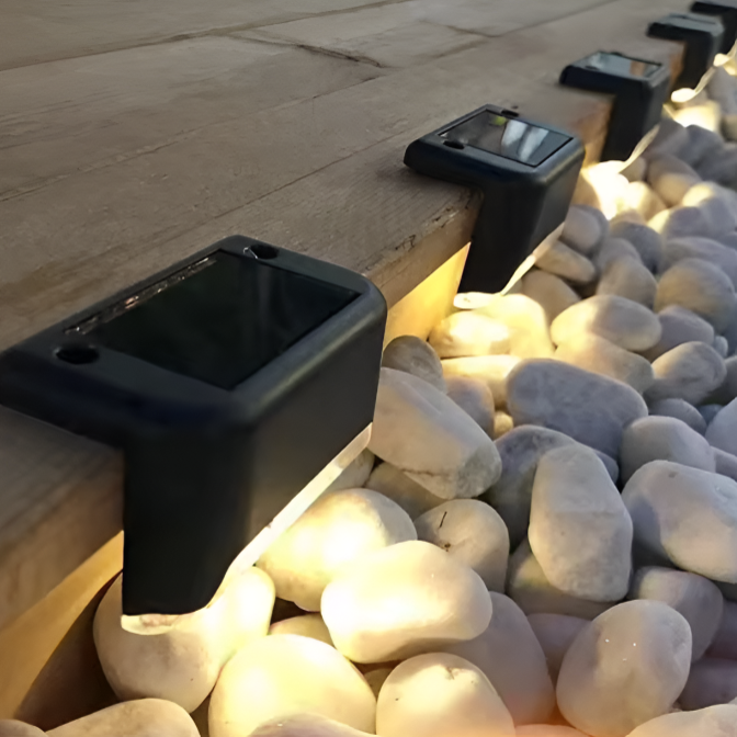 Solar outdoor lights glowing warm white on a staircase railing