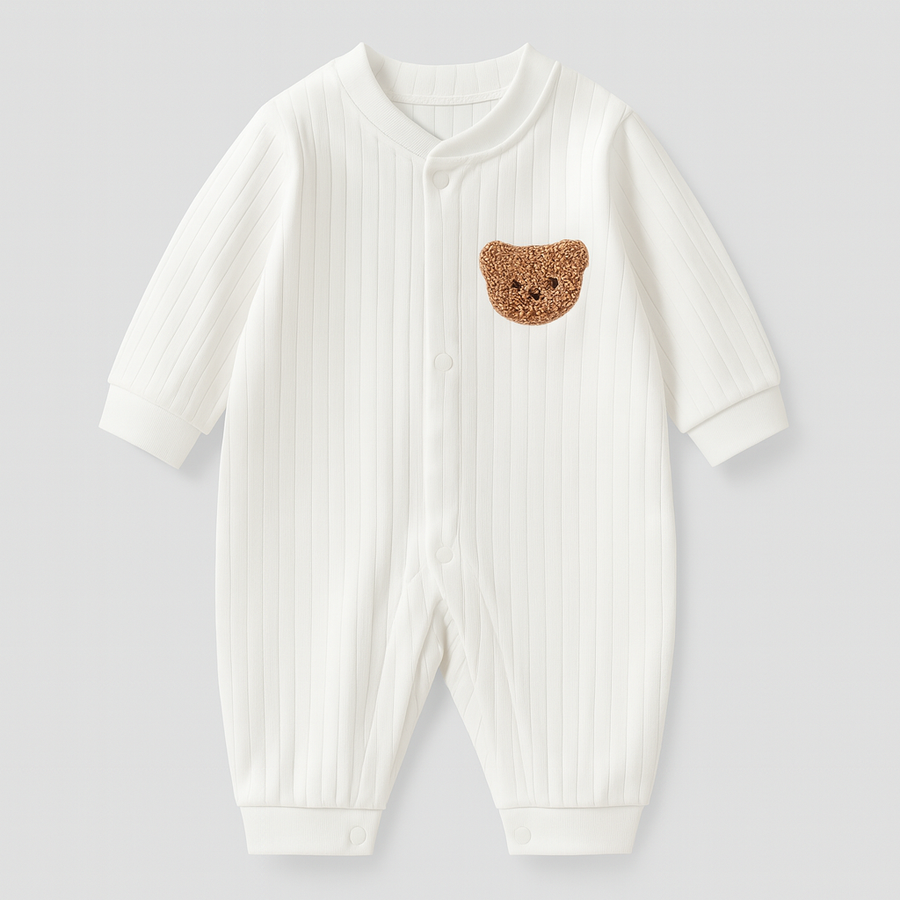 White ribbed baby overall with a crocheted bear patch on the chest