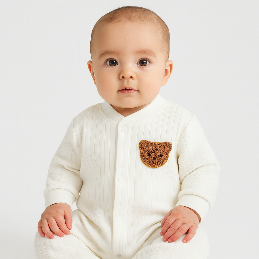 Close-up of the ribbed baby overall showing the soft knit texture