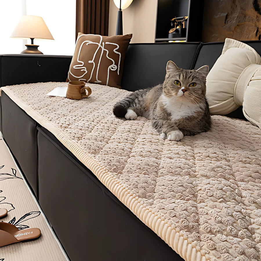 Knit non-slip sofa cover in a neutral color on a couch